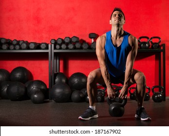 Kettlebell Swing Workout Training Man At Gym With Red Walls