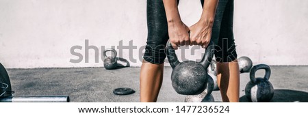 Kettlebell weightlifting woman lifting free weight panoramic banner gym. Hands holding heavy kettle bell for strength training exercise lifestyle.