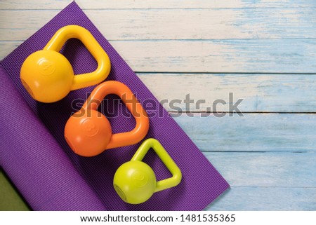 Kettlebell and yoga mat on table, fitness healthy and sport concept