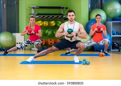 Kettlebells swing exercise man and woman workout at gym