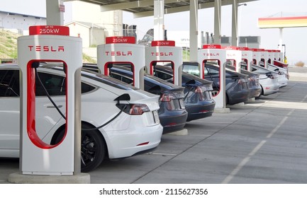 Kettleman City, CA - Jan 29, 2022: Many cars charging at a Tesla Supercharger station. Supercharger stations allow Tesla cars to be fast-charged at the network within a hour.