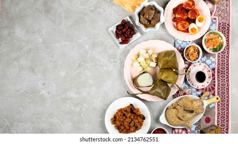 Ketupat Lebaran Ied Menu Dish, Opor Ayam, Sambal Goreng Ati Kentang, Balado Telur, Dates Fruit, Sambal, and Tea. Top View with Copy Space for Banner