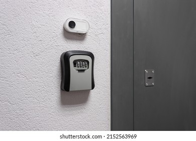 Key Box With A Combination Lock Next To The Door And A Bell Button On The Wall