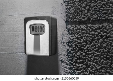 Key Box With Digital Mechanical Combination Lock On Black Painted Concrete Wall
