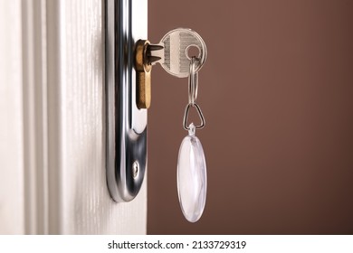 Key With Fob In Door Lock, Closeup. Space For Text