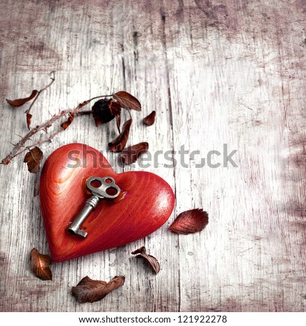 Key with the heart as a symbol of love/vintage card with red heart on grunge old background/valentines day background