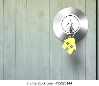 Key with house shape key-ring on lock old wooden door, nobody,3D rendering - Powered by Shutterstock