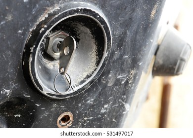 Key Inserted In The Ignition Lock Of An Old Farming Tractor