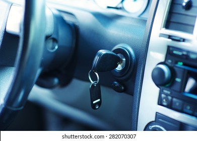 Key inserted into the lock of ignition of the car