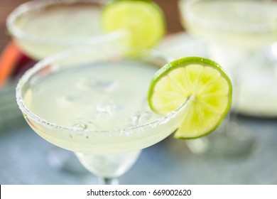 Key lime margarita garnished with fresh lime in margarita glass.