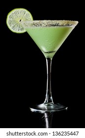 Key Lime Martini Isolated On A Black Background, Gram Cracker Rim And Lime Wheel Garnish