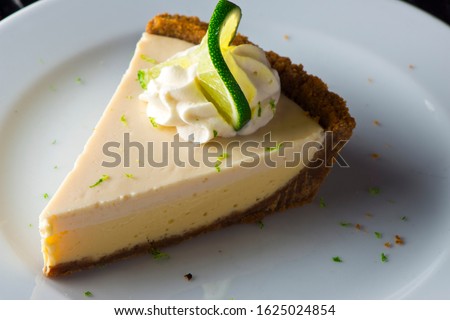
Key Lime Pie. Classic traditional American dessert favorite. Key lime pie, raw mixture made with the juice from Key West lime juice, condensed milk sugar and eggs poured into graham cracker crust. 