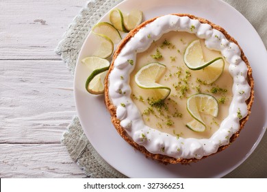 Key Lime Pie With Whipped Cream Close-up On The Table. Horizontal View From Above
