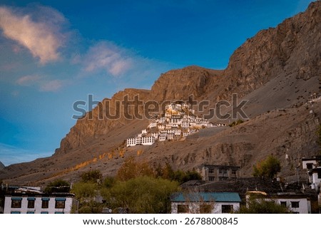 Key Monastery (Kye Gompa) glows at golden hour above the Spiti River, framed by rugged Himalayan peaks and prayer flags—serene, photogenic high-altitude panorama near Kaza.