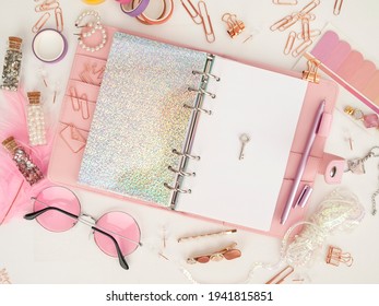 key on the white page of the planner. Diary open with white and holographic page. Pink planner with cute stationery. Top view of the pink planner with stationery. Pink glamour planner decoration photo