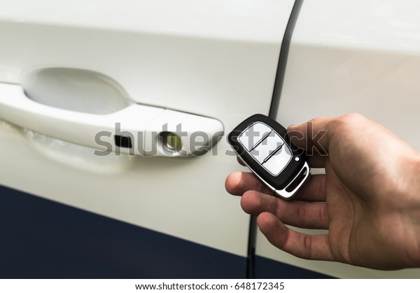 Key for opening car\
lock in man\'s hand