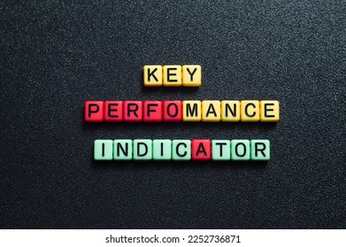 Key perfomance indicator - word concept on cubes, text, letters