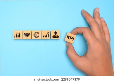 Key performance indicator, Businessman holding wooden cube with KPI - Shutterstock ID 2299047379