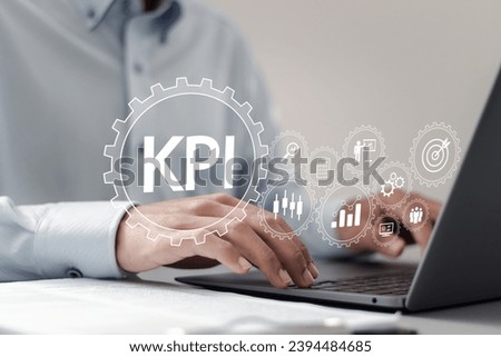 Key Performance Indicator concept. businessman using laptop with KPI icons on virtual screen to measure achievement versus planned target by using business Intelligence (BI) metrics.