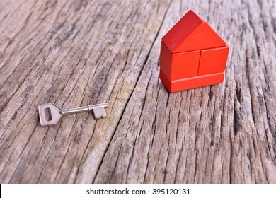 key and red stacked block on wooden background. Home conceptual
