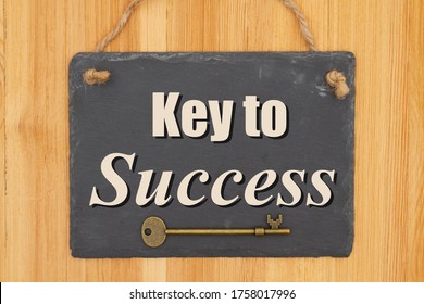 Key To Success Type Message On A Hanging Chalkboard Sign With Skeleton Key On Wood