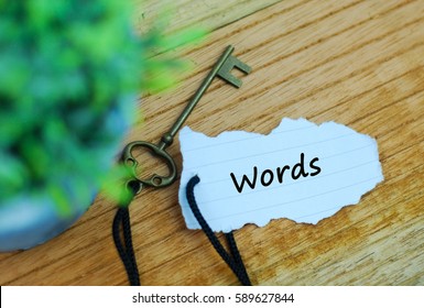 Key And Torn Paper With Text Words On Wooden Background. Keyword Concept