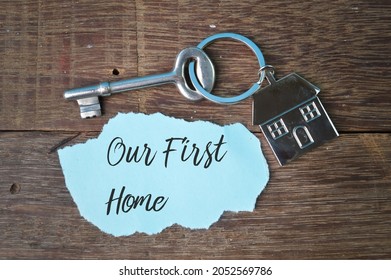 Key, toy house and torn paper written with text OUR FIRST HOME - Shutterstock ID 2052569786