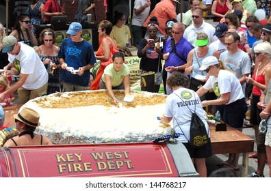 KEY WEST, FL-JULY4th:  Pieces Of The Largest Key Lime Pie In The World Are Handed Out To Tourists And Locals Alike On July 4, 2013, In Key West, Florida, At The First Annual Key Lime Pie Festival.