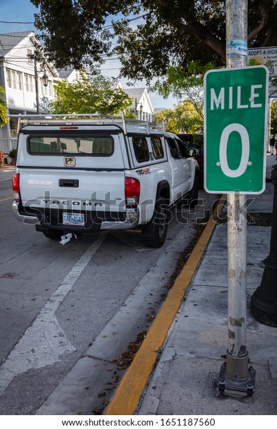 Key\
West, Florida - 14 February 2020: Truck parked next to Mile Marker\
0 which is the beginning of US-1 up the East\
Coast