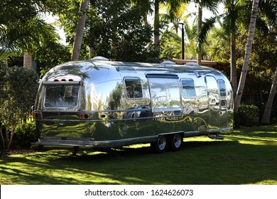 Key West, Florida, January 2020: Airstream iconic American caravan vintage travel trailer on green grass