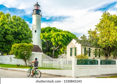 Key West, Florida, USA - September 13, 2019: Man Riding Bike Near Key West Lighthouse, Florida USA