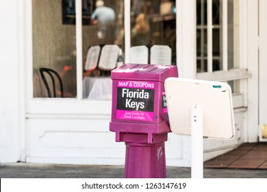 Key West, USA - May 1, 2018: Purple Free Newspaper, Magazine Stand, Dispenser, Box, Area Guide Book, Map, Coupons In Florida Keys Urban City On Duval Street Sidewalk, Nobody