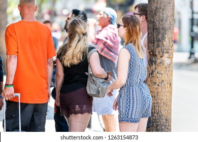 Key West, USA - May 1, 2018: Group Of Young People, Tourists, Couple, Woman Standing, Waiting On Sidewalk Of Duval Street Road In Summer By Restaurant Entrance, Line, Queue In Florida Keys City