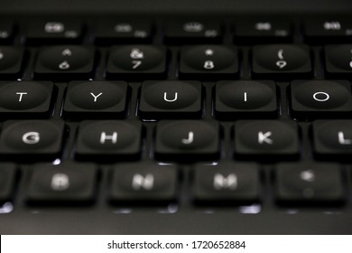 Keyboard with Backlight and Keys Light Up on Black Background