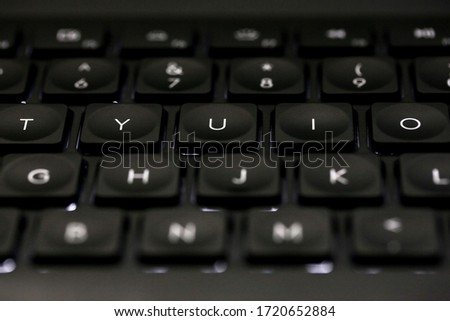 Keyboard with Backlight and Keys Light Up on Black Background