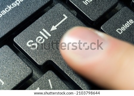 Keyboard button close-up focus on the enter button saying Sell
