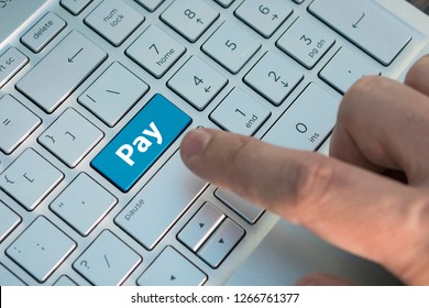 Keyboard with golden button pay - electronic payment and e-banking concept, disbursement, remuneration, paid, A male finger presses a color button on a gray silver keyboard of a modern laptop. - Shutterstock ID 1266761377