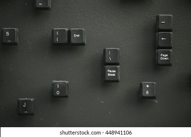 Keyboard key buttons on the black plate randomly organized and selected, shallow depth of field, macro shot, focus is on pause and break keys
