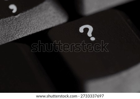 Keyboard key in focus with question mark, symbolizing curiosity and user interaction.