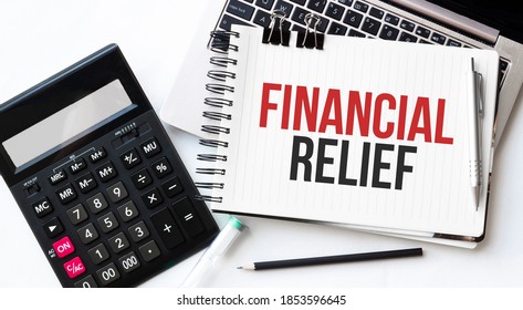 Keyboard Of Laptop, Calcualtor, Pencil And Notepad With Text Financial Relief On The White Background