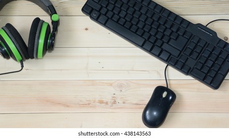 keyboard and mouse computer with headset on woods