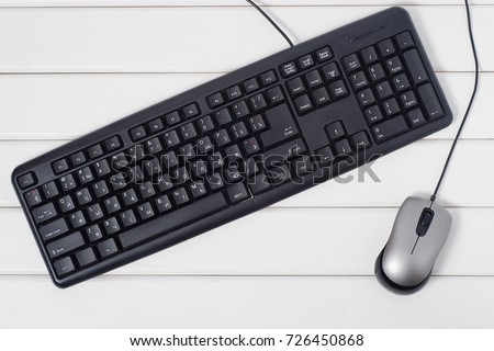 Keyboard mouse from computer on white wooden background isolation