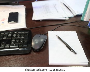 Keyboard, mouse, notebook on the table