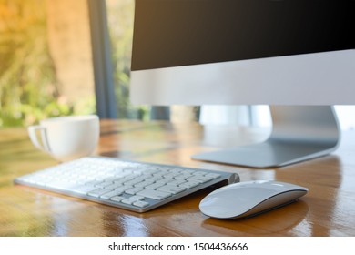 Keyboard, mouse, screen, computer, coffee cup, placed on the desk