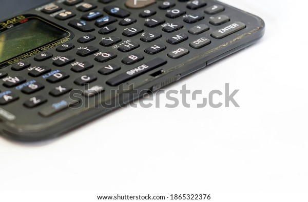 The keyboard of an old electronic organizer with\
liquid crystal display isolated on a white background. Obsolete\
technology of the 90s
