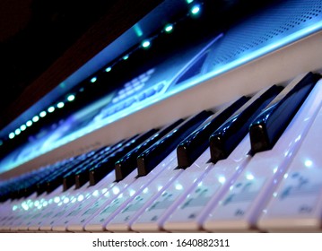 
Keyboard synthesizer piano keys in the night light of neon lights. Music Studio Producer