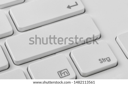 A keyboard with an unlabeled button
