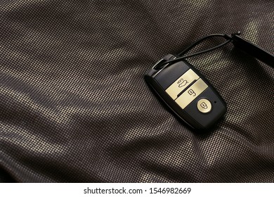 Keychain car keys lie on a dark golden background - Powered by Shutterstock