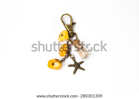 Keychain made with antique gold, glass and amber isolated on the white background