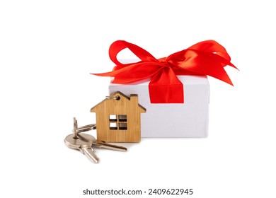 Keychain in the shape of a house with a key ring isolated on white background. Concepts for real estate and moving home or renting property. Buying a property. Mock-up keychain house shaped.Copy space